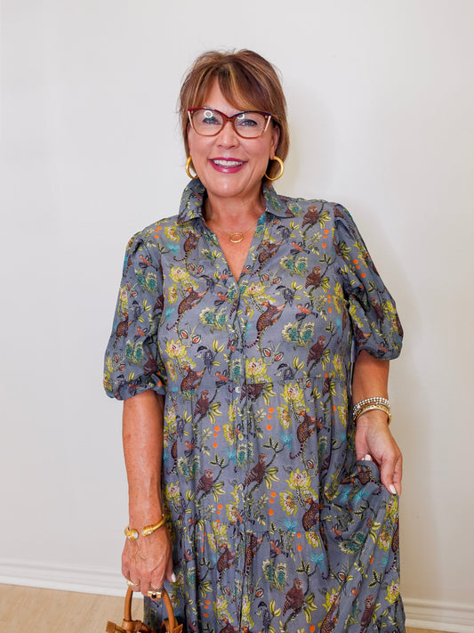 Woman wearing a floral dress with a plain background
