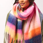 Person wearing a colorful striped scarf on a white background