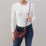 Hobo Astrid Small Crossbody in mulberry glaze leather with top zip closure and adjustable strap.