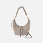 Gray suede handbag with braided handle on a white background