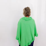 Person wearing a green poncho against a white background
