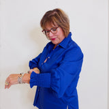 Woman wearing a blue shirt against a white background