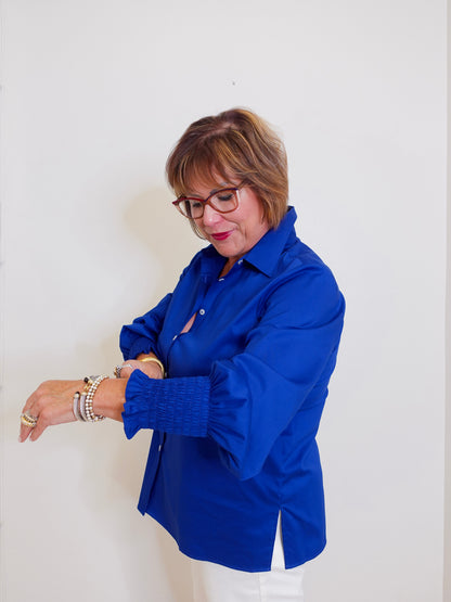 Woman wearing a blue shirt against a white background