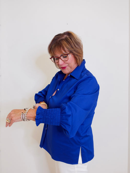 Woman wearing a blue shirt against a white background