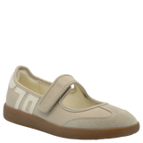 Beige children's shoe with a brown sole on a white background