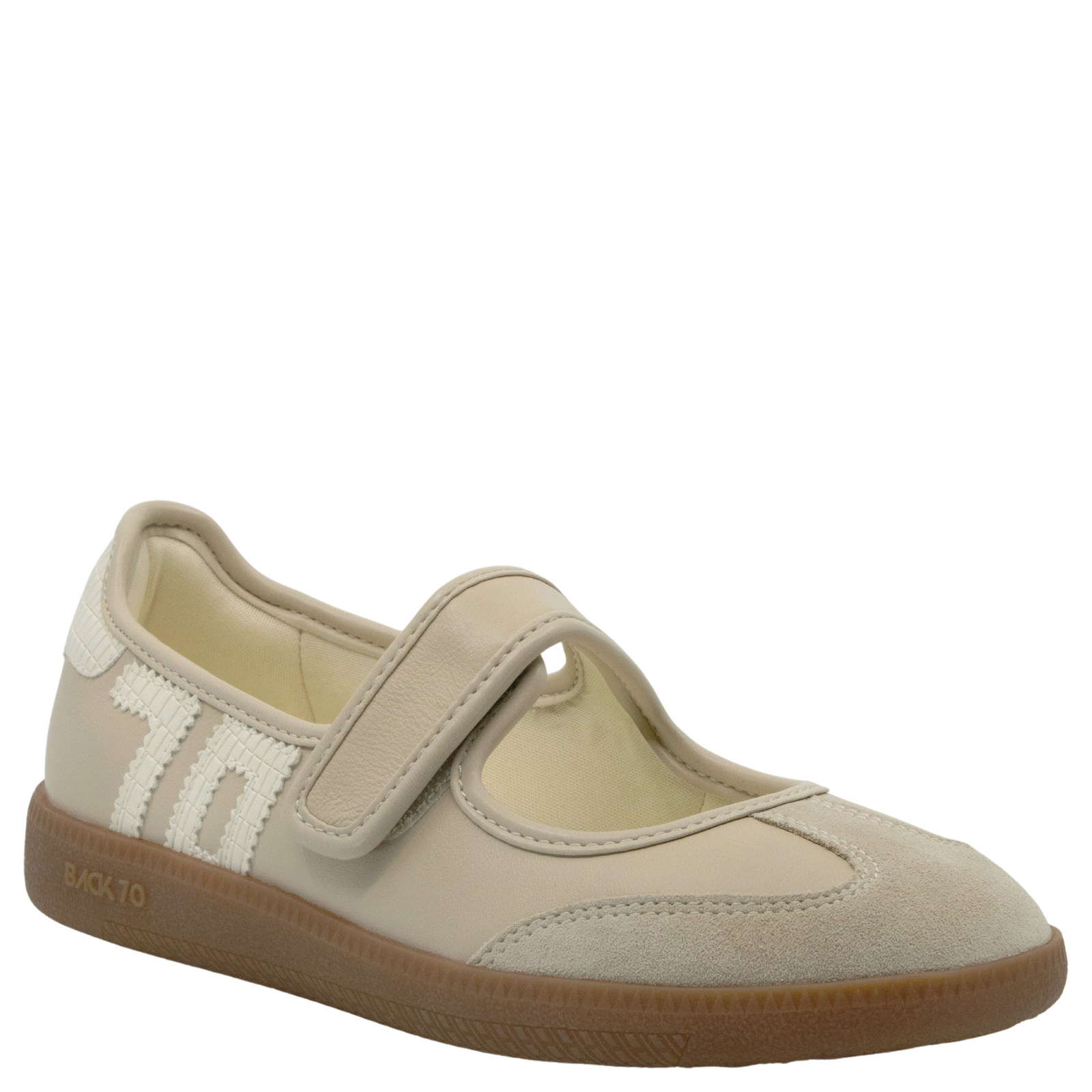 Beige children's shoe with a brown sole on a white background
