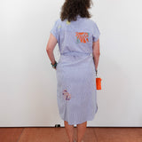 Person wearing a light blue dress with a floral pattern on a white background