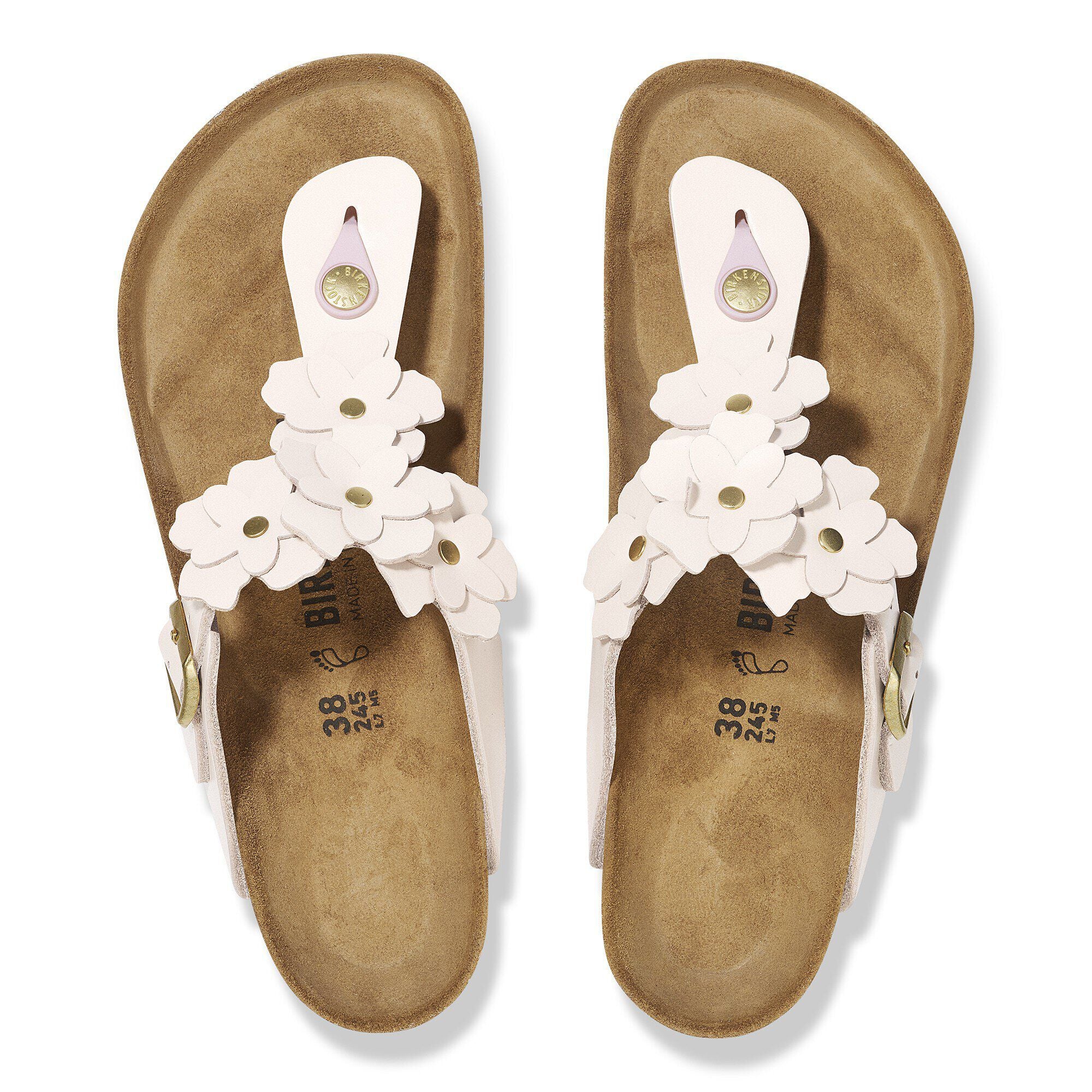 Pair of sandals with white floral straps on a white background
