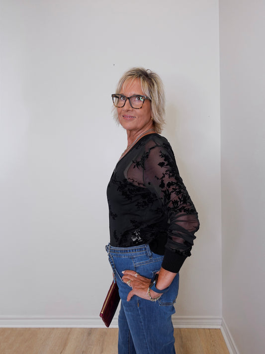 Black 2-piece mesh cardigan and tank set paired with blue jeans, modeled by a woman holding a maroon handbag.