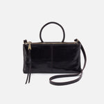 A black leather sable crossbody handbag with a shoulder strap and a zipper closure.