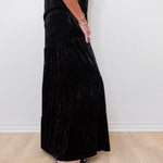 Person wearing a black dress with a white background