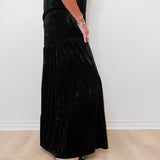 Person wearing a black dress with a white background