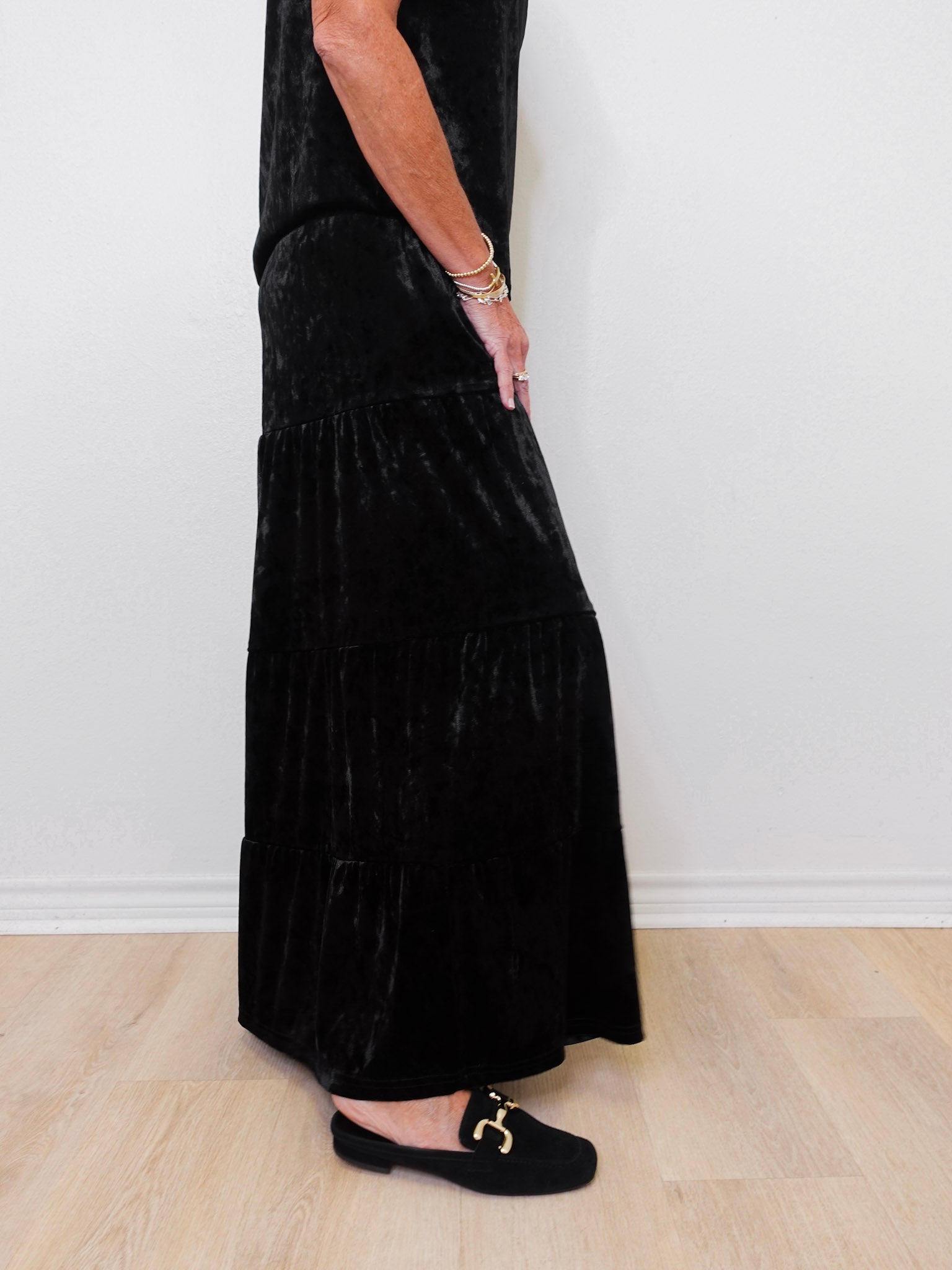 Person wearing a black dress with a white background