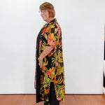 Woman wearing a floral dress with a black background