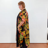 Woman wearing a floral dress with a black background