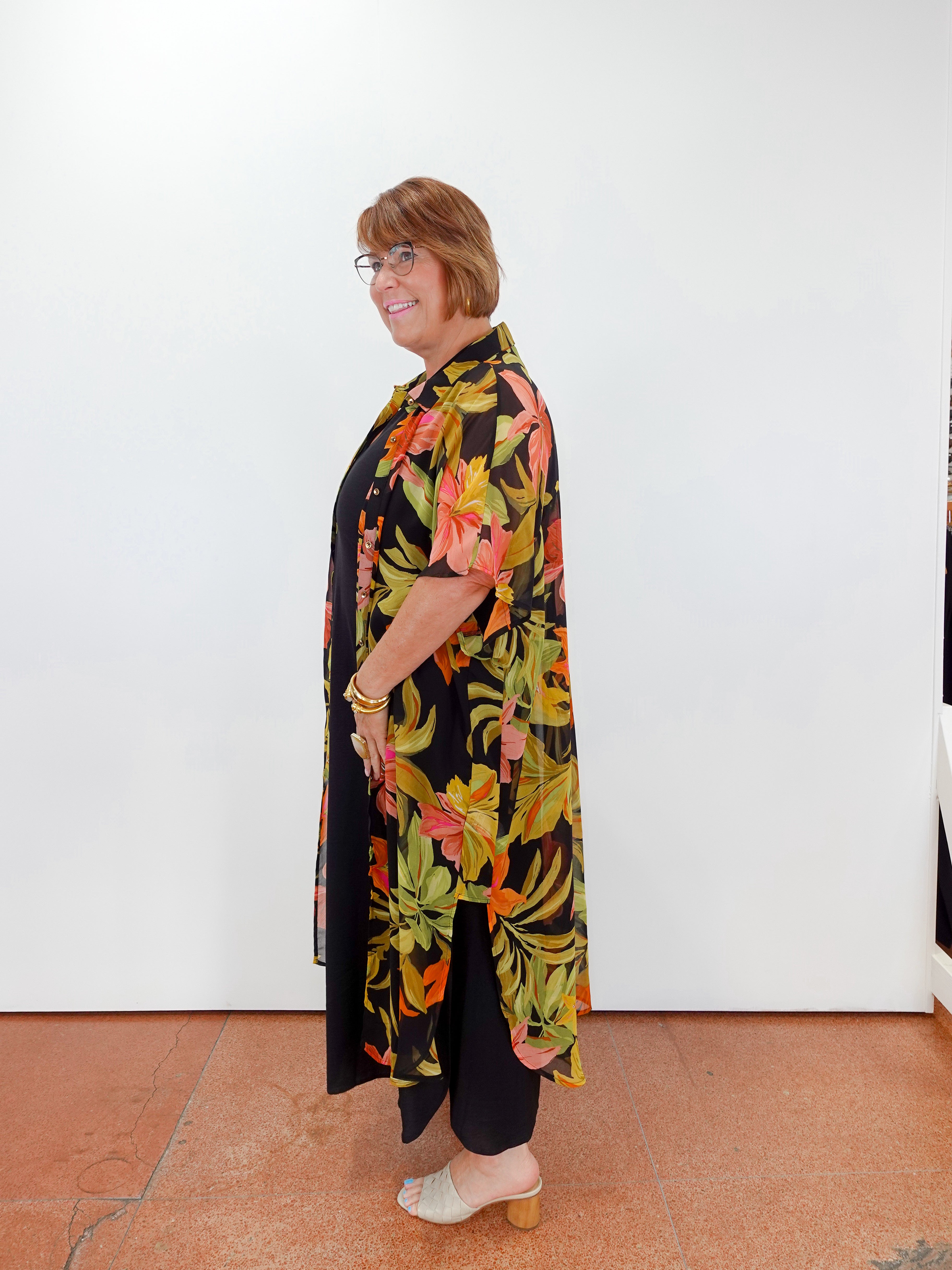 Woman wearing a floral dress with a black background