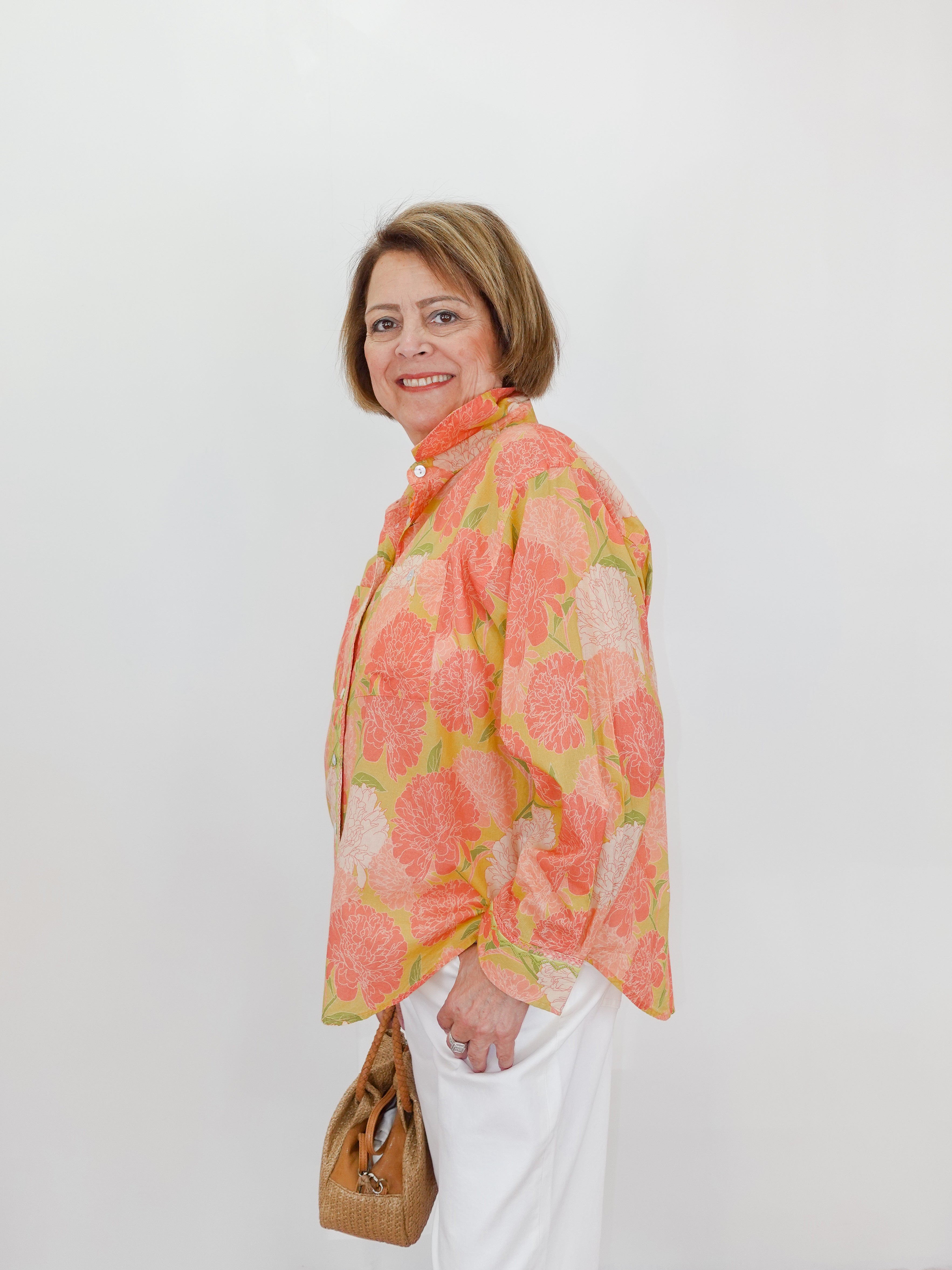 Woman wearing a floral scarf against a white background
