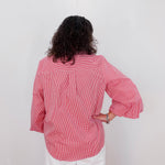 Person wearing a red checkered shirt against a white background