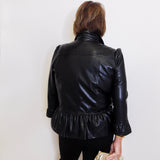 Person wearing a black leather jacket with a white background