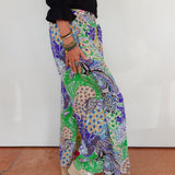 Person wearing colorful patterned pants with a plain background