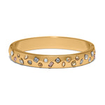 Gold bracelet with embedded gemstones on a white background