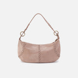 Pink handbag with braided handle on a light gray background