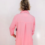Person wearing a pink jacket against a white background