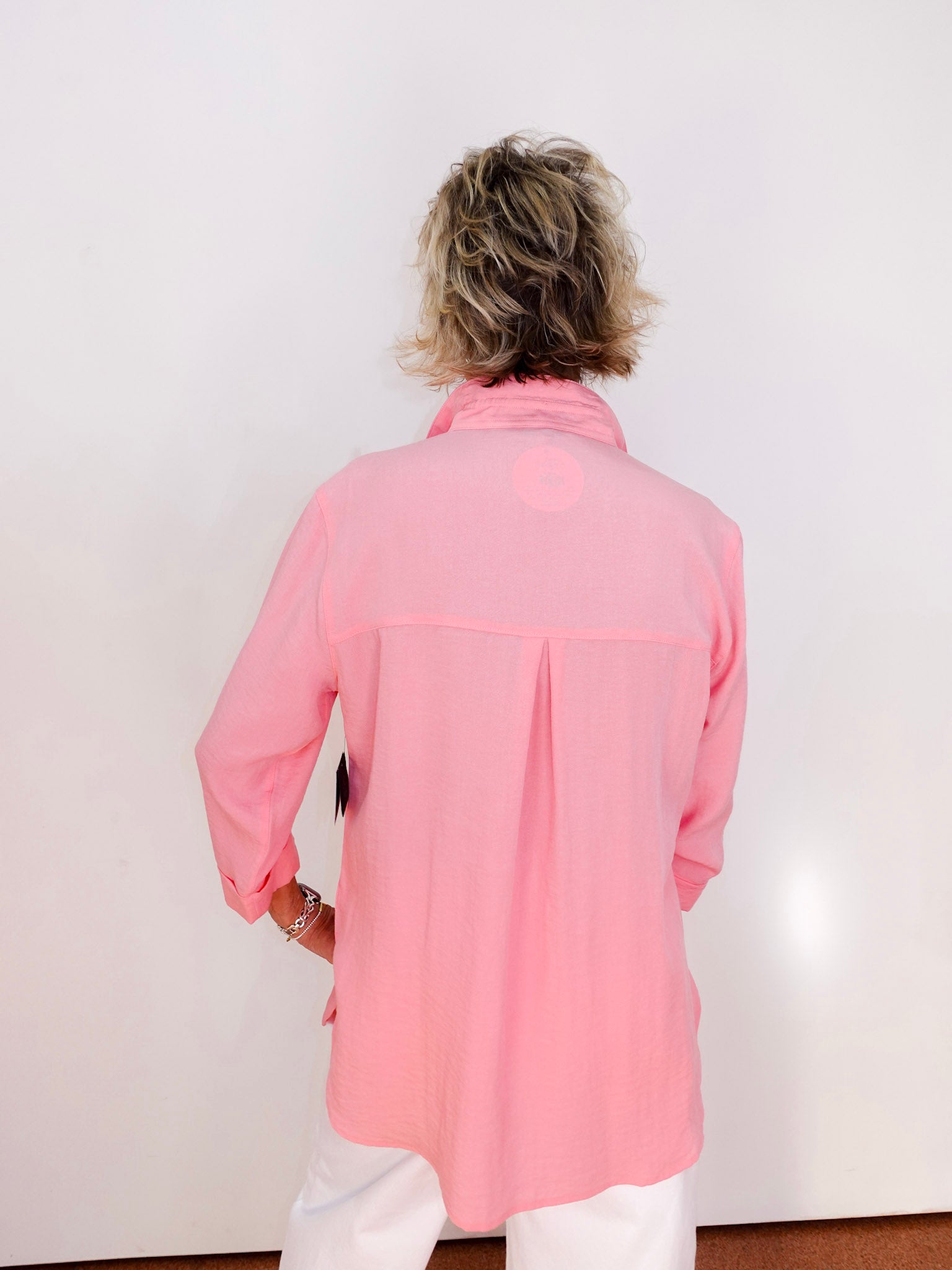 Person wearing a pink jacket against a white background