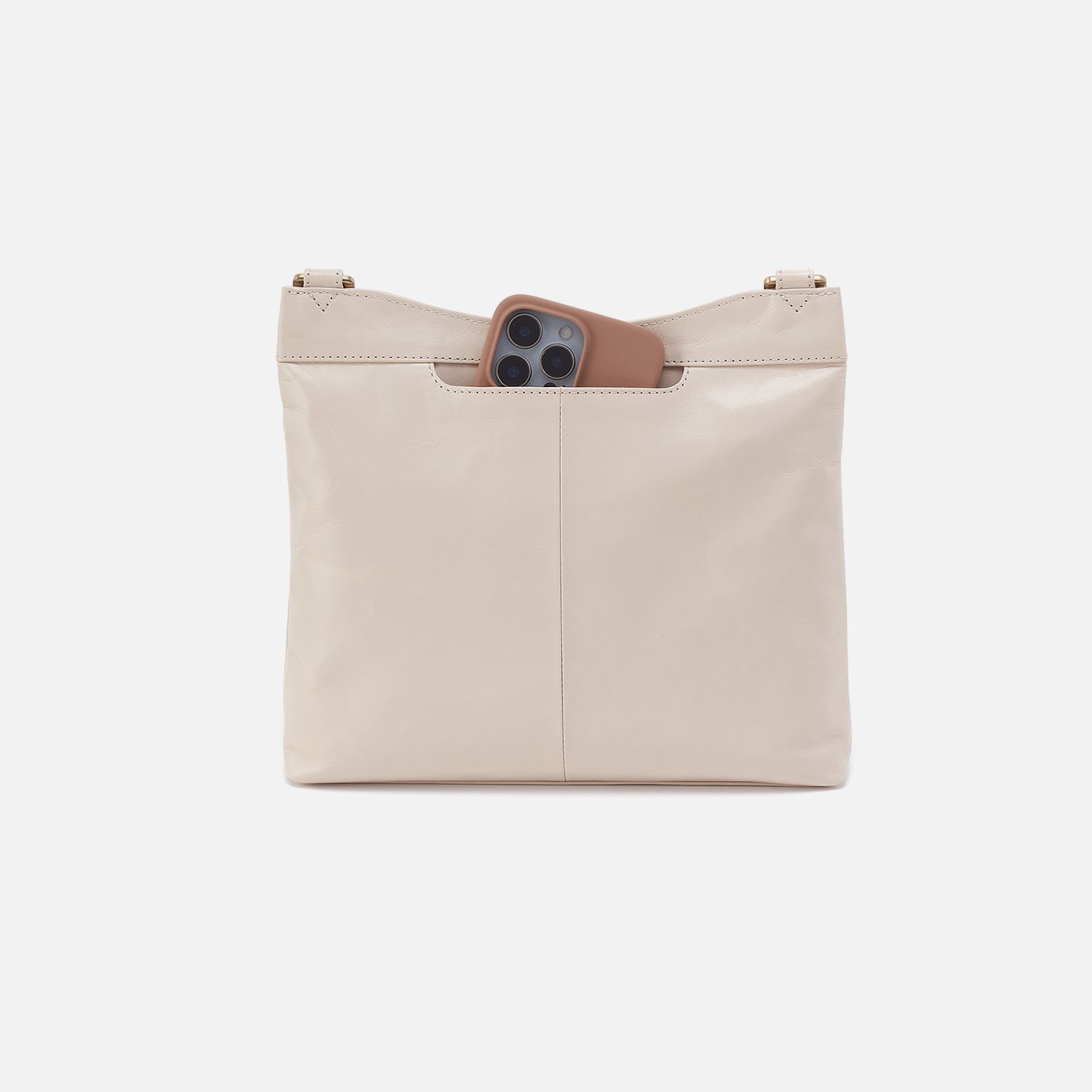 Beige leather bag with a pocket holding a phone on a white background