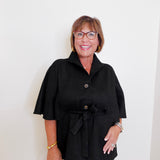 Woman wearing a black coat with a white background