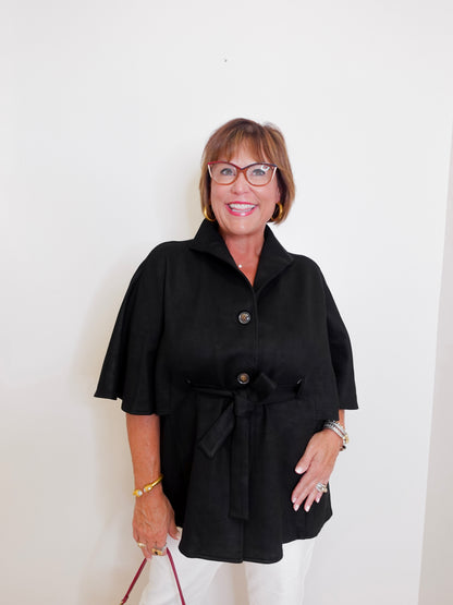Woman wearing a black coat with a white background