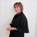 Woman wearing a black outfit with a white background