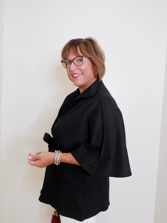 Woman wearing a black outfit with a white background