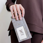 woman holding the Beige cardholder with zipper on a white background