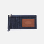 Navy blue cardholder with a brown leather patch on a light gray background