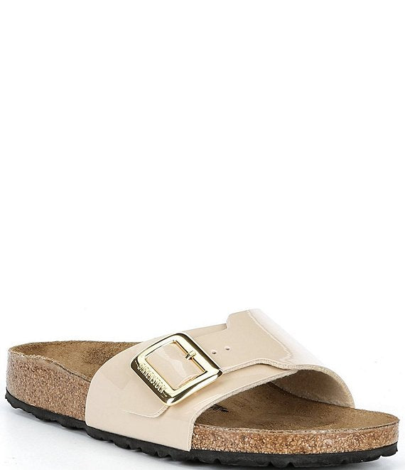 Beige sandal with a gold buckle on a white background