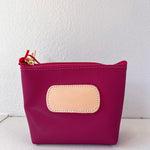 Pink pouch with a beige patch on a white background