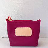 Pink pouch with a beige patch on a white background
