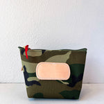 Camouflage pouch with a pink patch on a white background