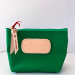 Green pouch with beige patch and red zipper pull on a white background