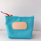 Blue pouch with a beige patch on a white background