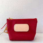 Red pouch with a beige patch on a white background