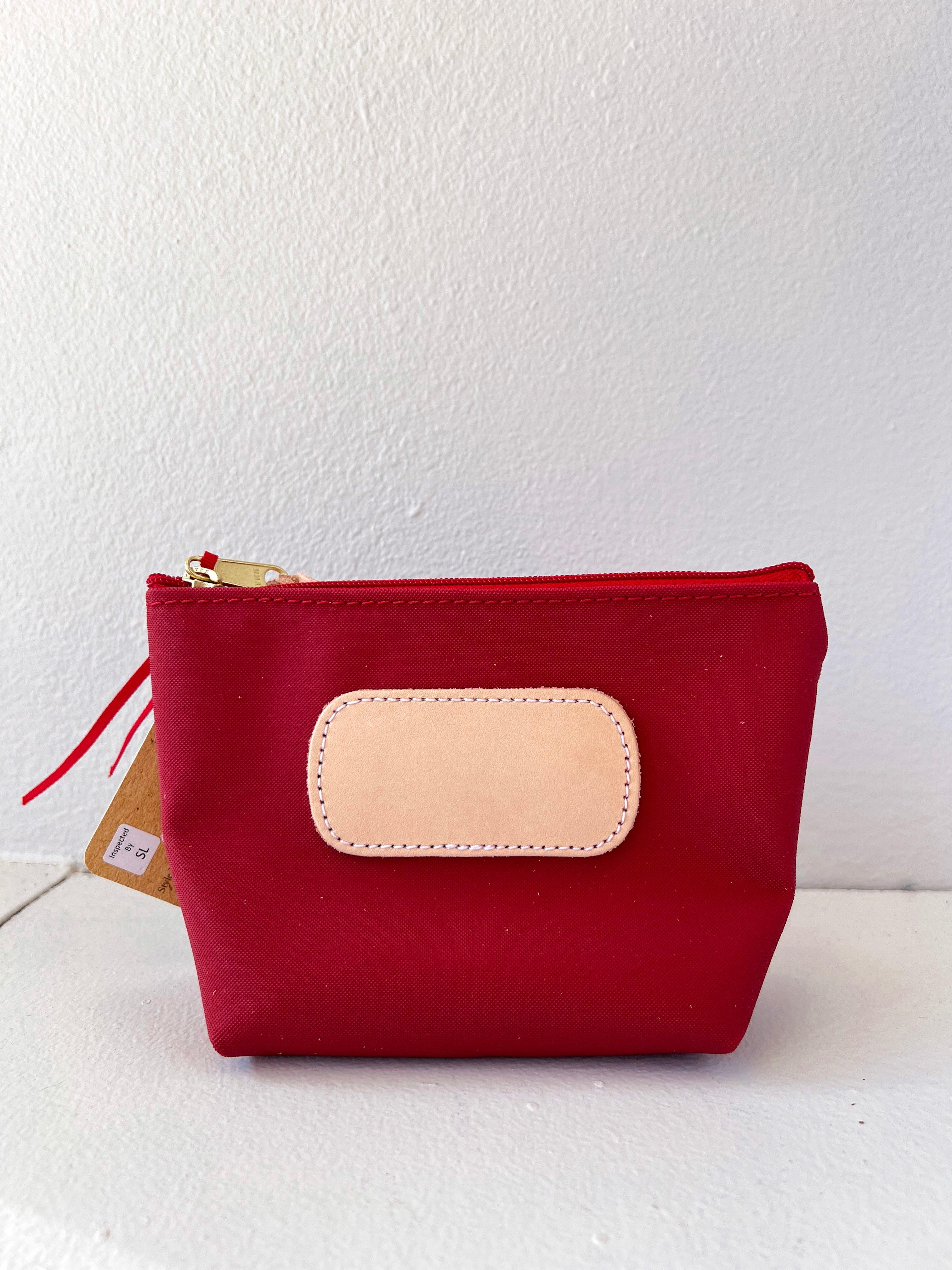 Red pouch with a beige patch on a white background
