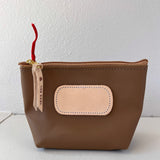 Brown pouch with beige patch and red string on a white background