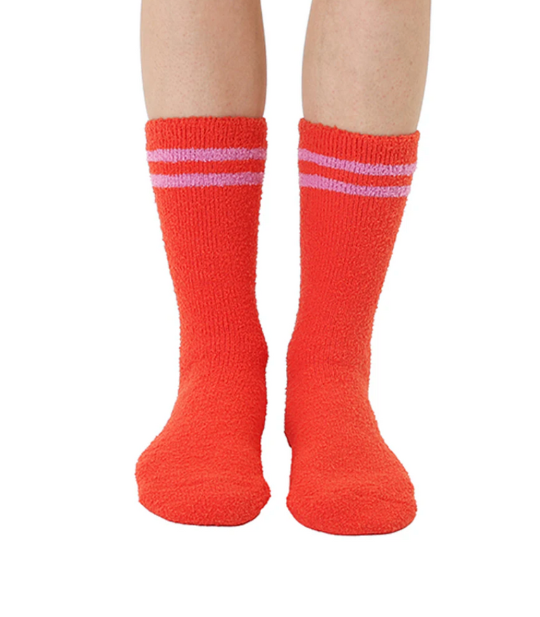 Red socks with white stripes worn by a person on a white background