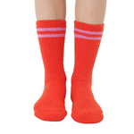 Red socks with white stripes worn by a person on a white background