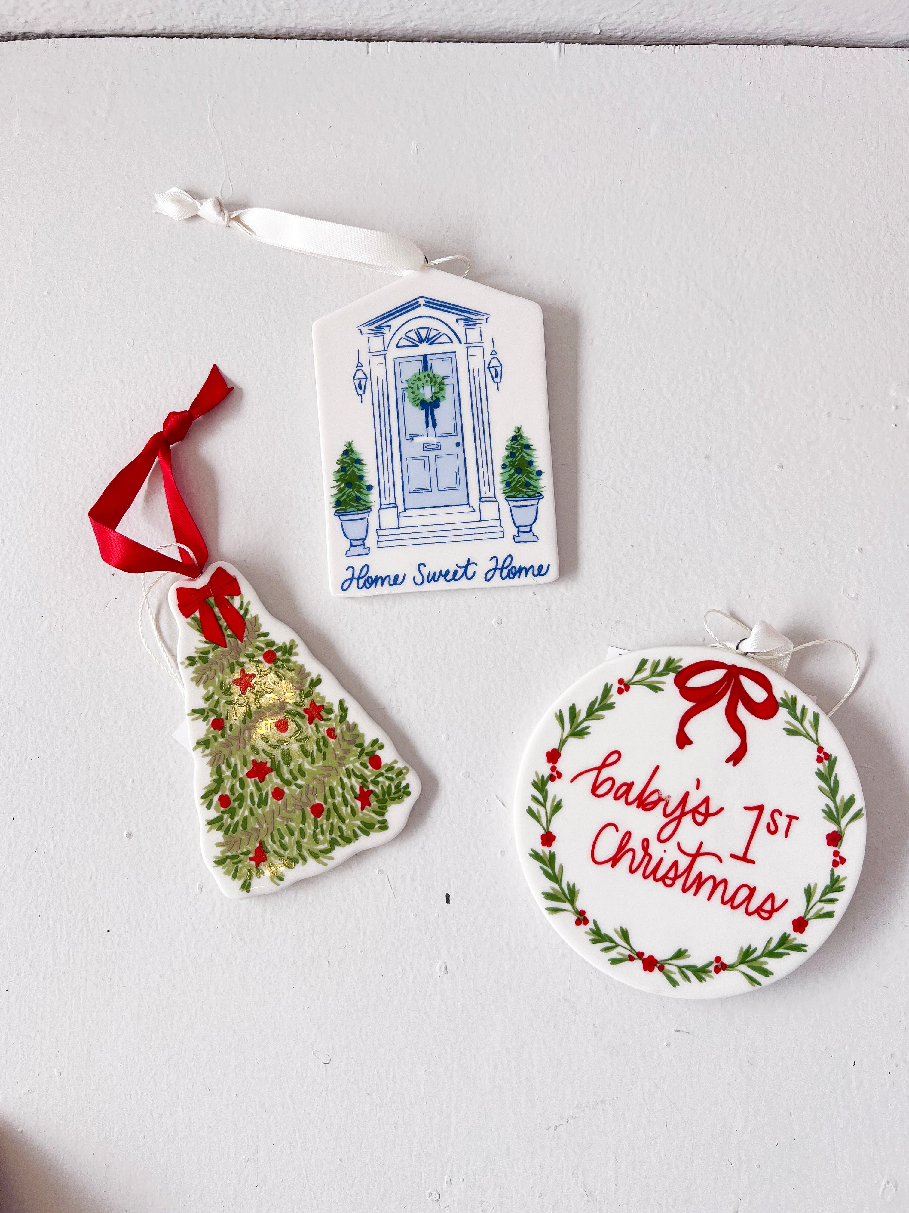 Three Christmas-themed ceramic ornaments on a light gray background