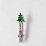 Decorative spoon with a Christmas tree design on a white background