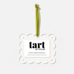 Decorative photo frame ornament with green ribbon and 'tart by Taylor' label on a white background