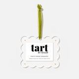 Decorative photo frame ornament with green ribbon and 'tart by Taylor' label on a white background
